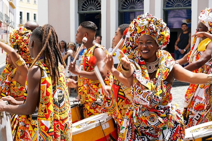 Dancer's small parade with traditional costumes celebrating with revelers the Carnival on the streets. Salvadore, Bahia, Brazil, 02/11/2019